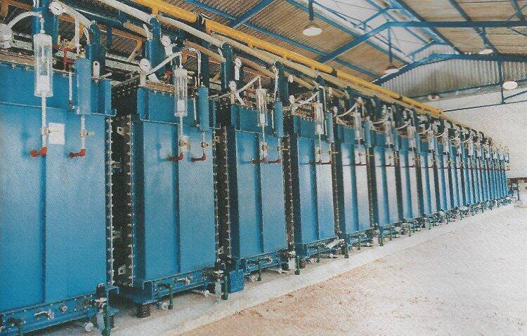 A row of blue rectifiers at a clean electricity plant.
